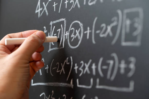 Algebra equations being worked out on a chalkboard